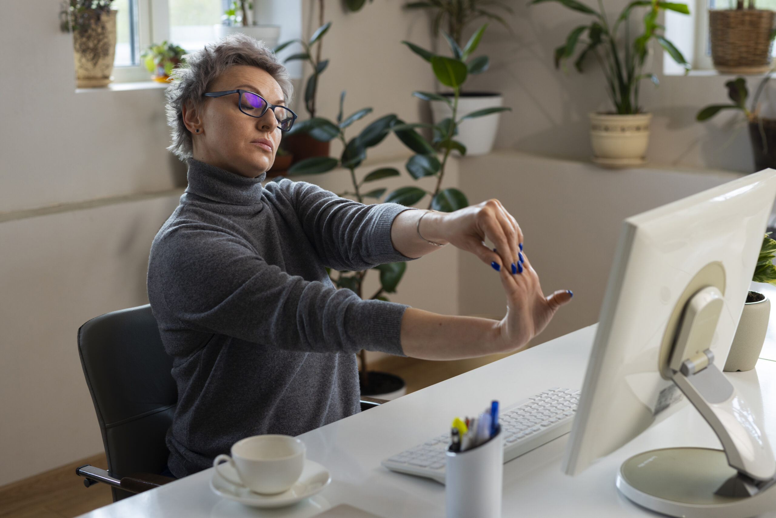 medium shot woman stretching desk